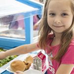 a student reaching for salad